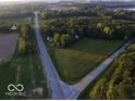 Aerial shot of roads leading to the property surrounded by green spaces and scattered trees at 18378 Southeastern Pkwy, Fortville, IN 46040