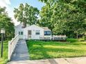 Charming single-story home with a wheelchair ramp and inviting front yard, surrounded by trees at 18378 Southeastern Pkwy, Fortville, IN 46040