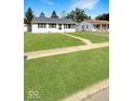 Well-maintained lawn with convenient sidewalk access to front door of nearby single Gathering home at 205 Eikenberry St, Greenfield, IN 46140