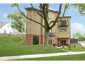 Modern home with a large tree in the yard, featuring balconies and tan siding at 2130 Brookside Pkwy N Dr, Indianapolis, IN 46201