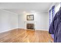 Bright living room features hardwood floors, decorative fireplace with mantel, with natural light streaming through the windows at 2359 Seattle Slew Dr, Indianapolis, IN 46234