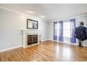 Cozy living room featuring hardwood floors, a fireplace with a decorative mantel, and sun-filled windows at 2359 Seattle Slew Dr, Indianapolis, IN 46234