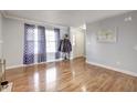 Inviting living room with gleaming hardwood floors, neutral paint, and large windows providing ample natural light at 2359 Seattle Slew Dr, Indianapolis, IN 46234