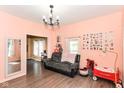 Cozy living room with hardwood floors, neutral walls, and bright natural light, ideal for relaxing at 2702 S Moreland Ave, Indianapolis, IN 46241