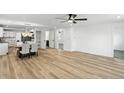 Open-concept living and dining area with hardwood floors and modern white walls at 2715 S A St, Elwood, IN 46036
