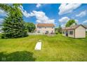 Expansive backyard featuring a large shed, mature trees, and a well-manicured lawn at 296 Myers Lake Dr, Noblesville, IN 46062