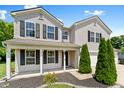 Inviting two-story home featuring a covered porch with elegant columns and a neatly landscaped yard at 3058 Mcintosh Dr, Bargersville, IN 46106