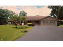 Charming single-story ranch home with a well-manicured lawn and attached two-car garage at 3422 Sycamore Dr, Columbus, IN 47203