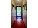 Hallway with hardwood floors leads to the front door, providing an inviting entrance at 3422 Sycamore Dr, Columbus, IN 47203