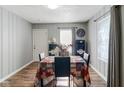 Cozy dining room with hardwood floors, neutral walls, and a dining table set for four at 3508 Brouse Ave, Indianapolis, IN 46218