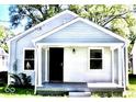 Charming bungalow with horizontal siding, a porch, and a black front door at 3508 Brouse Ave, Indianapolis, IN 46218
