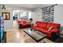 Inviting living room featuring hardwood floors, colorful decor, and a comfortable seating area at 3508 Brouse Ave, Indianapolis, IN 46218