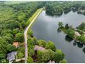 Stunning aerial view of a home nestled among lush greenery, with a serene lake and expansive landscape at 3813 N Ramsgate Rd, Martinsville, IN 46151