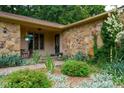 Inviting front porch with stone accents, lush landscaping, and a pathway leading to the front door at 3813 N Ramsgate Rd, Martinsville, IN 46151