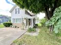 Charming two-story home with a covered side porch and lush landscaping, set on a green lawn at 4096 N 200 W, Greenfield, IN 46140