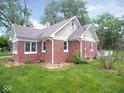 Brick home with a gabled roof, trimmed windows and green lawn at 4219 Mathews Ave, Indianapolis, IN 46227
