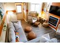 Comfortable living room featuring stylish decor, wood floors, fireplace, and an egg chair at 5704 Carrousel Dr, Indianapolis, IN 46254