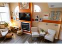 Stylish living room with fireplace, hardwood floors, accent walls and contemporary furnishings at 5704 Carrousel Dr, Indianapolis, IN 46254