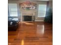 Spacious living room featuring a cozy fireplace, hardwood floors, and natural light at 6334 Winslow Dr, Indianapolis, IN 46237