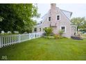 Well-maintained backyard with a white picket fence and lush landscaping at 643 Harlan St, Plainfield, IN 46168