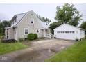 Charming home with a detached two-car garage and concrete driveway at 643 Harlan St, Plainfield, IN 46168