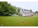 Expansive front yard featuring a charming two-story home with a white picket fence at 643 Harlan St, Plainfield, IN 46168
