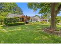 Beautiful brick ranch home with mature trees and neatly trimmed bushes at 649 Lawndale Dr, Plainfield, IN 46168