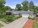 Landscaped front yard and long driveway leading to this single Gathering home at 649 Lawndale Dr, Plainfield, IN 46168