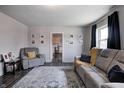 Inviting living room with modern decor, featuring a comfortable gray sofa and stylish rug at 725 2Nd St, Shelbyville, IN 46176