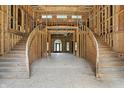 Unfinished grand foyer featuring a dual staircase and framed doorway at 7843 E Triple Crown Ln, Camby, IN 46113