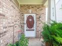 Inviting front porch with brick accents, decorative door, and charming landscaping, perfect for welcoming guests at 8125 Whistlewood Dr, Indianapolis, IN 46239