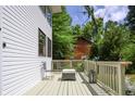 Side deck offers a cozy outdoor seating area with lovely landscaping and access to the front door at 8167 Center Lake Rd, Nineveh, IN 46164