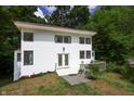 Charming two-story home with a white exterior, front deck, and surrounded by lush trees at 8167 Center Lake Rd, Nineveh, IN 46164