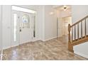 The bright foyer has tile floors, a decorative door, and a staircase at 8909 Carnation Dr, Noblesville, IN 46060
