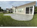 Large stamped concrete patio offering scenic views of the backyard and access to the screened porch at 9404 Crystal River Dr, Indianapolis, IN 46240