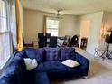 Inviting living room showcases a comfortable blue sofa and a dining area with modern chairs at 9621 Gemini Dr, Indianapolis, IN 46229