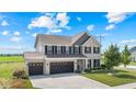 Spacious two-story home featuring a three-car garage and a well-maintained lawn at 9986 Gallop Ln, Fishers, IN 46040