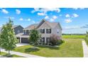 Attractive two-story house showcasing a three-car garage and verdant landscaping at 9986 Gallop Ln, Fishers, IN 46040