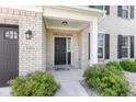 Inviting front porch with brick accents and well-manicured landscaping at 9986 Gallop Ln, Fishers, IN 46040