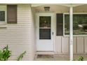 Close-up of a white front door, brown shutters, and a welcoming welcome mat at 10155 Orchard Park W Dr, Carmel, IN 46280