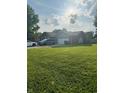Well-maintained brick home with a spacious front yard, featuring an attached garage and a neatly kept lawn at 1050 Laguna Ln, Greenwood, IN 46143