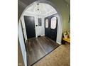 Inviting foyer with stylish wood flooring, decorative lighting, and a beautifully designed arched doorway at 1050 Laguna Ln, Greenwood, IN 46143