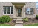 Inviting front entrance with brick columns, covered porch, and well-kept landscaping at 1246 Valdosta Pl, Westfield, IN 46074