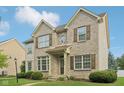 Charming two-story brick home with a well-manicured lawn and decorative shutters at 1246 Valdosta Pl, Westfield, IN 46074