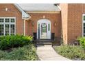 Inviting front entrance with a decorative wreath, charming lanterns, and manicured greenery at 14030 Old Mill Ct, Carmel, IN 46032