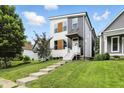 Charming two-story home with landscaped yard and inviting walkway leading to the front door at 1406 Linden St, Indianapolis, IN 46203