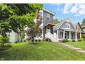 Beautiful front yard with healthy grass, a modern home exterior, and lovely neighborhood setting at 1406 Linden St, Indianapolis, IN 46203