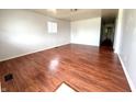 Spacious living room with gleaming hardwood floors, neutral wall color, and ample natural light at 1509 S Rural St, Indianapolis, IN 46203