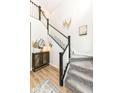 Open foyer featuring a staircase, wood floors, and stylish decor at 16283 Spring Bank Ct, Fishers, IN 46040