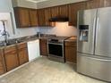 Spacious kitchen featuring a stainless steel refrigerator, oven, and classic wood cabinets at 1807 Park North Bnd, Indianapolis, IN 46260